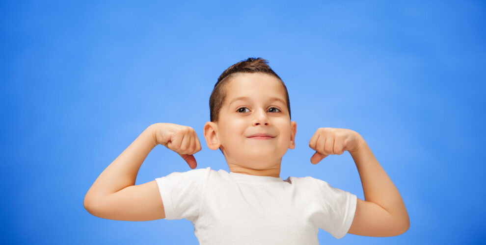 beauty smiling sport child boy showing his biceps scaled